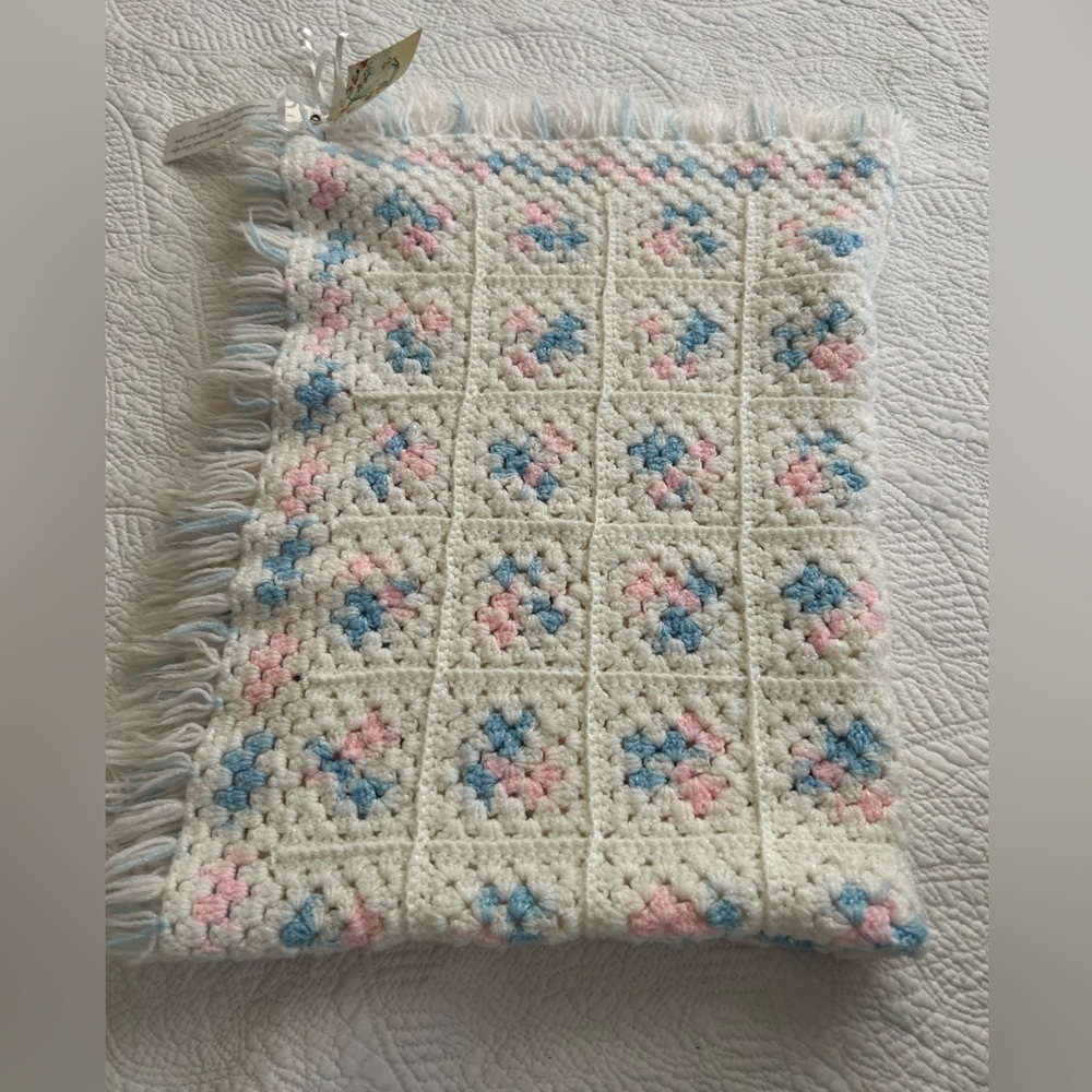 NWT Handknit Baby Blanket. White with pink and blue design. 40 X 27.5. Fringe